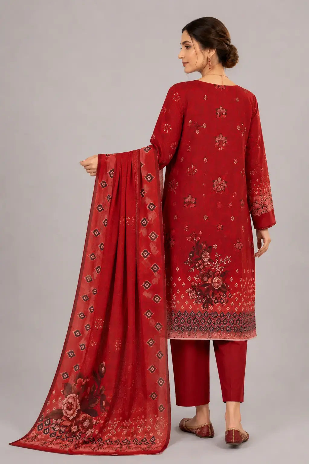 This is a Bin Saeed Lawn collection design in red color. Women wearing this dress and pose is back side.