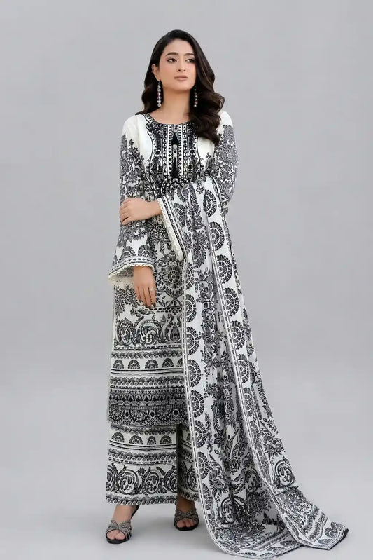 Woman wearing a black and white patterned shalwar kameez on a gray background