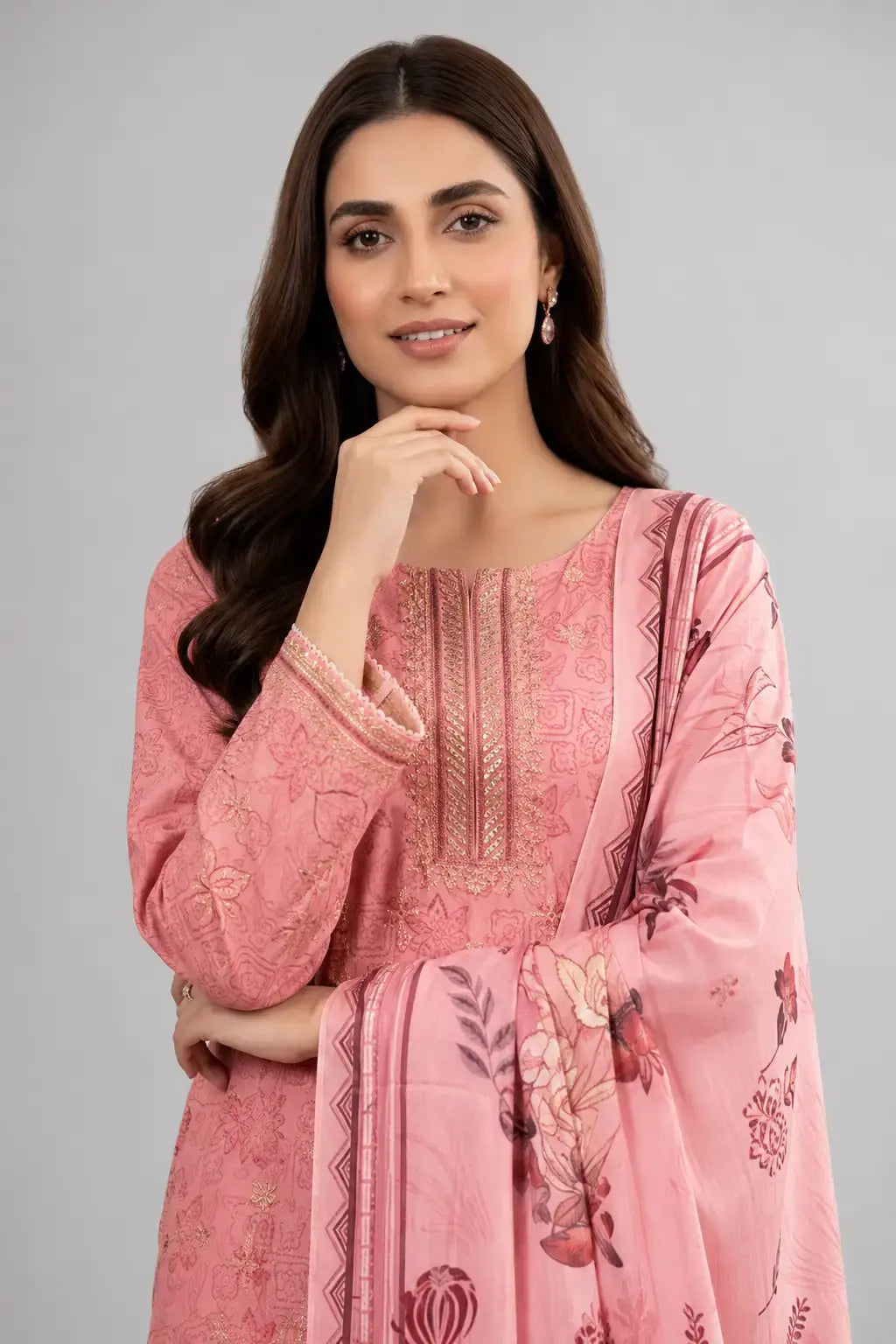 Woman wearing a pink luxury lawn with floral patterns