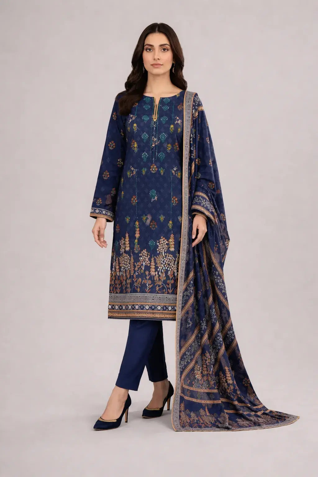 Woman wearing a blue traditional shalwar kameez with a matching dupatta on a white background
