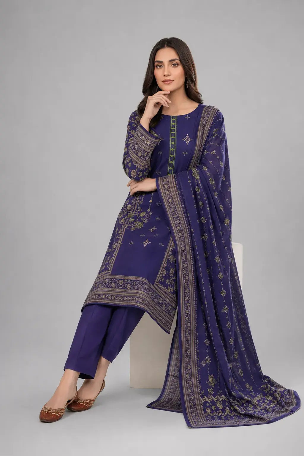 Woman wearing a blue shalwar kameez dress design with matching printed duppata and plain trouser