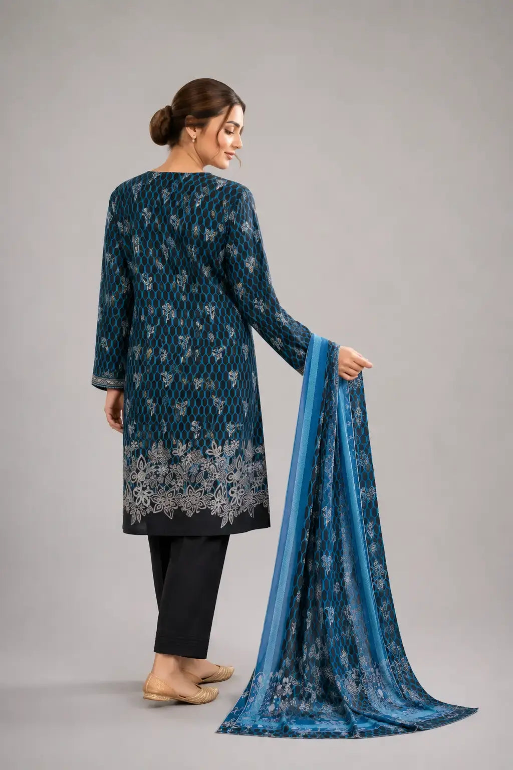 Woman wearing a blue traditional shalwar kameez  with a matching dupatta and black plain trouser