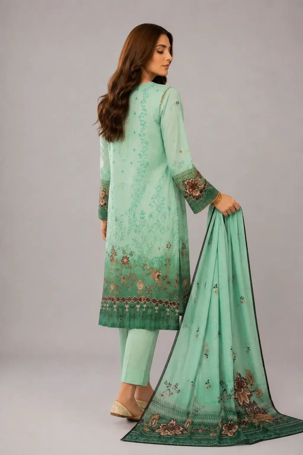 Woman wearing a light green outfit with a matching dupatta