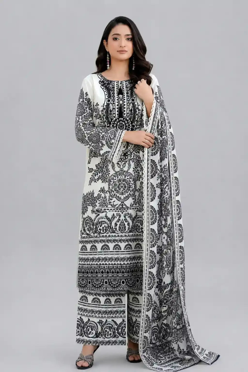 Woman wearing a black and white Sobia Nazir Lawn design with same printed trouser and matching dupatta
