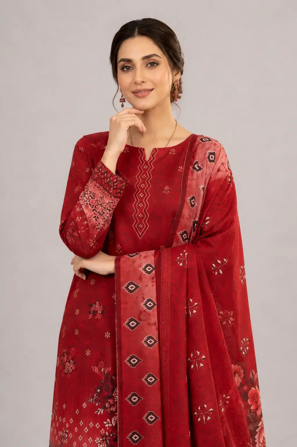 Woman wearing a red luxury lawn dress design with matching digital print dupatta and plain trouser