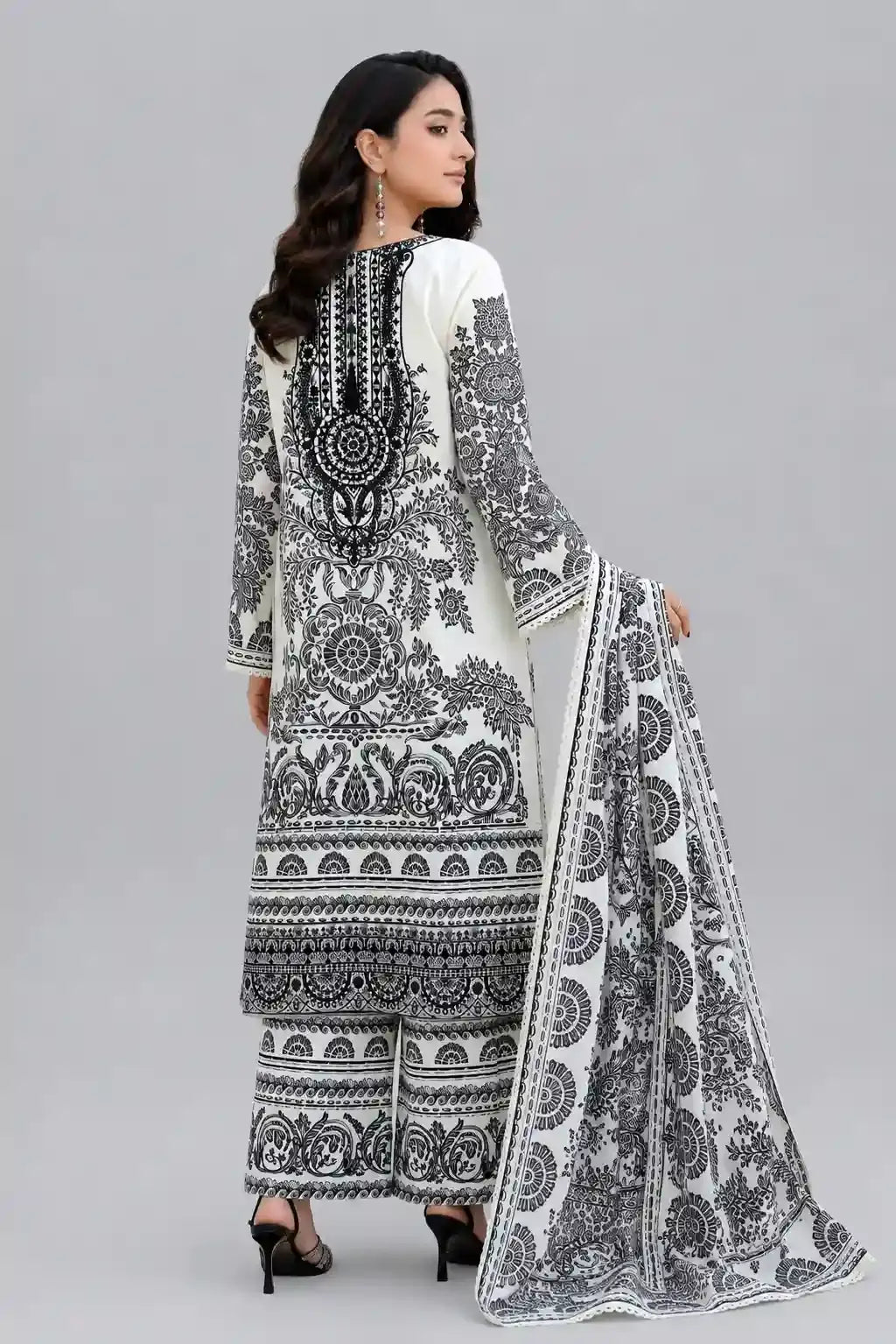 Woman wearing a black and white patterned printed Pakistani Dress