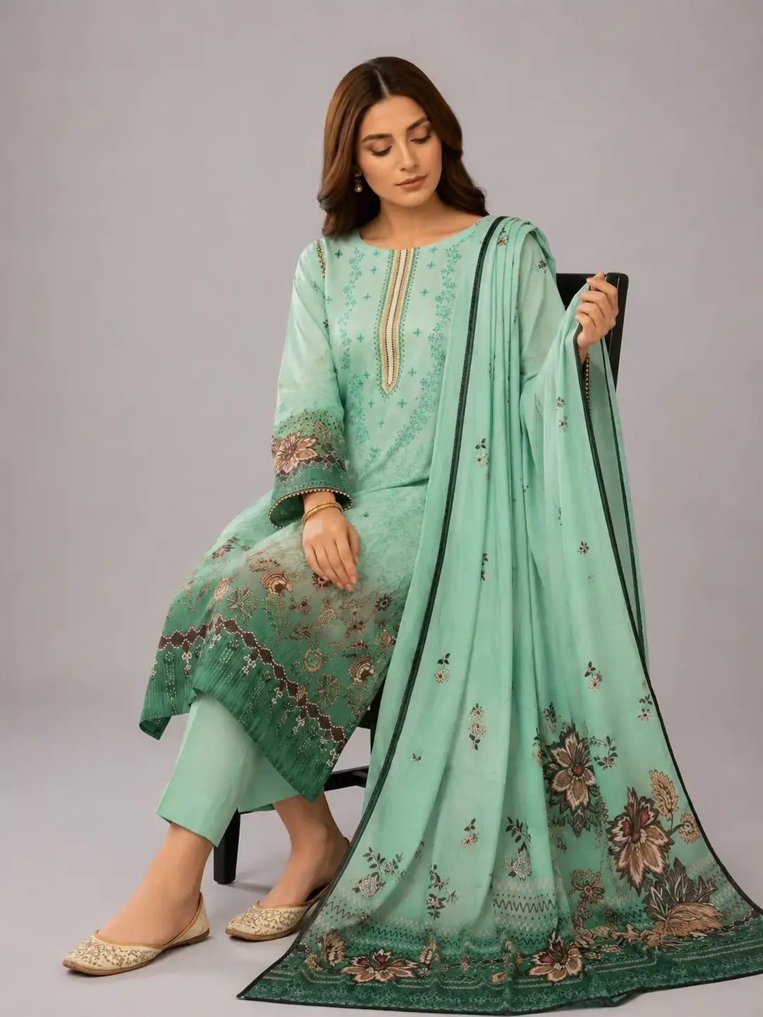 Woman wearing a light green digital printed Pakistani dress with a matching lawn dupatta