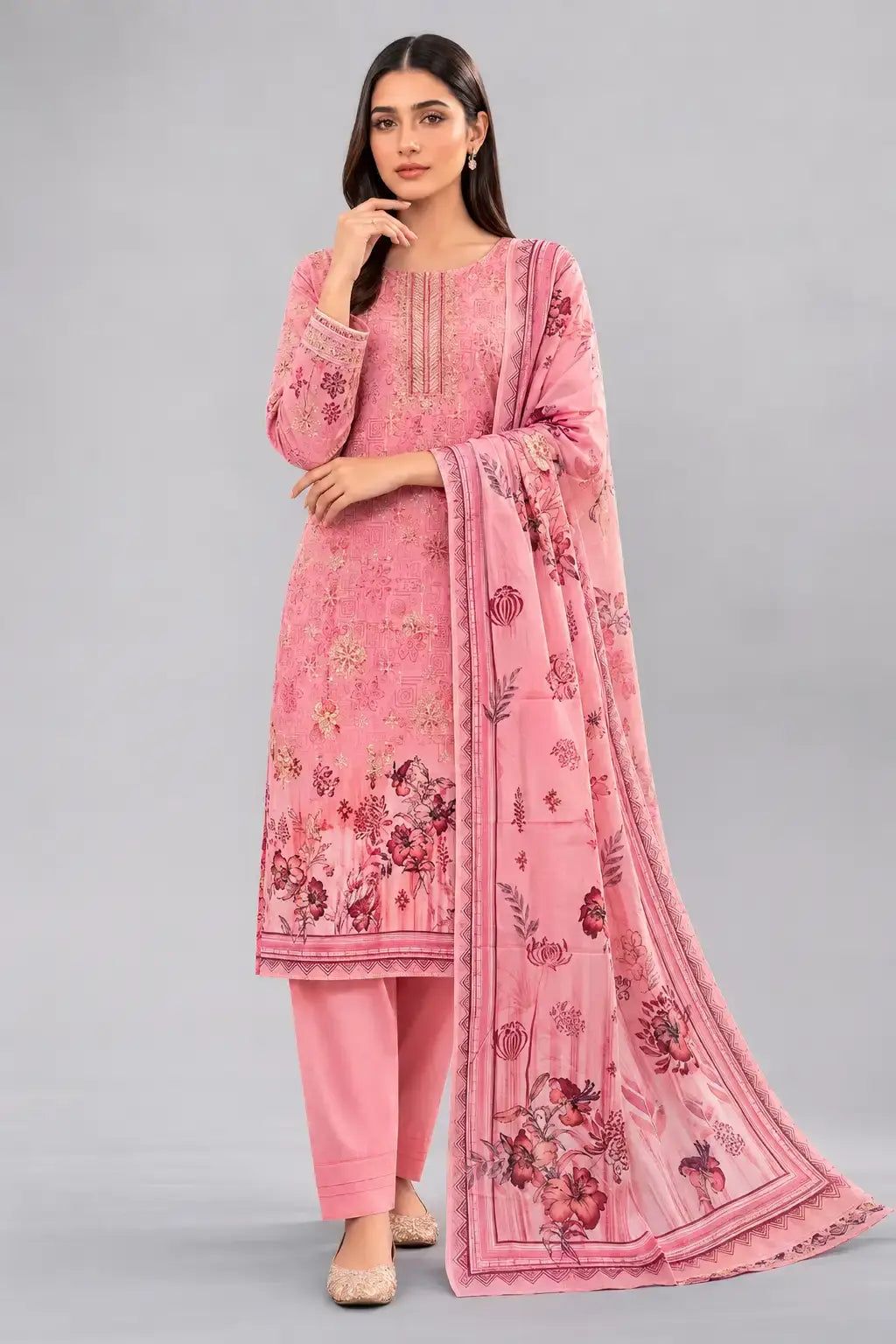 Woman wearing a pink digital print traditional outfit with a matching dupatta