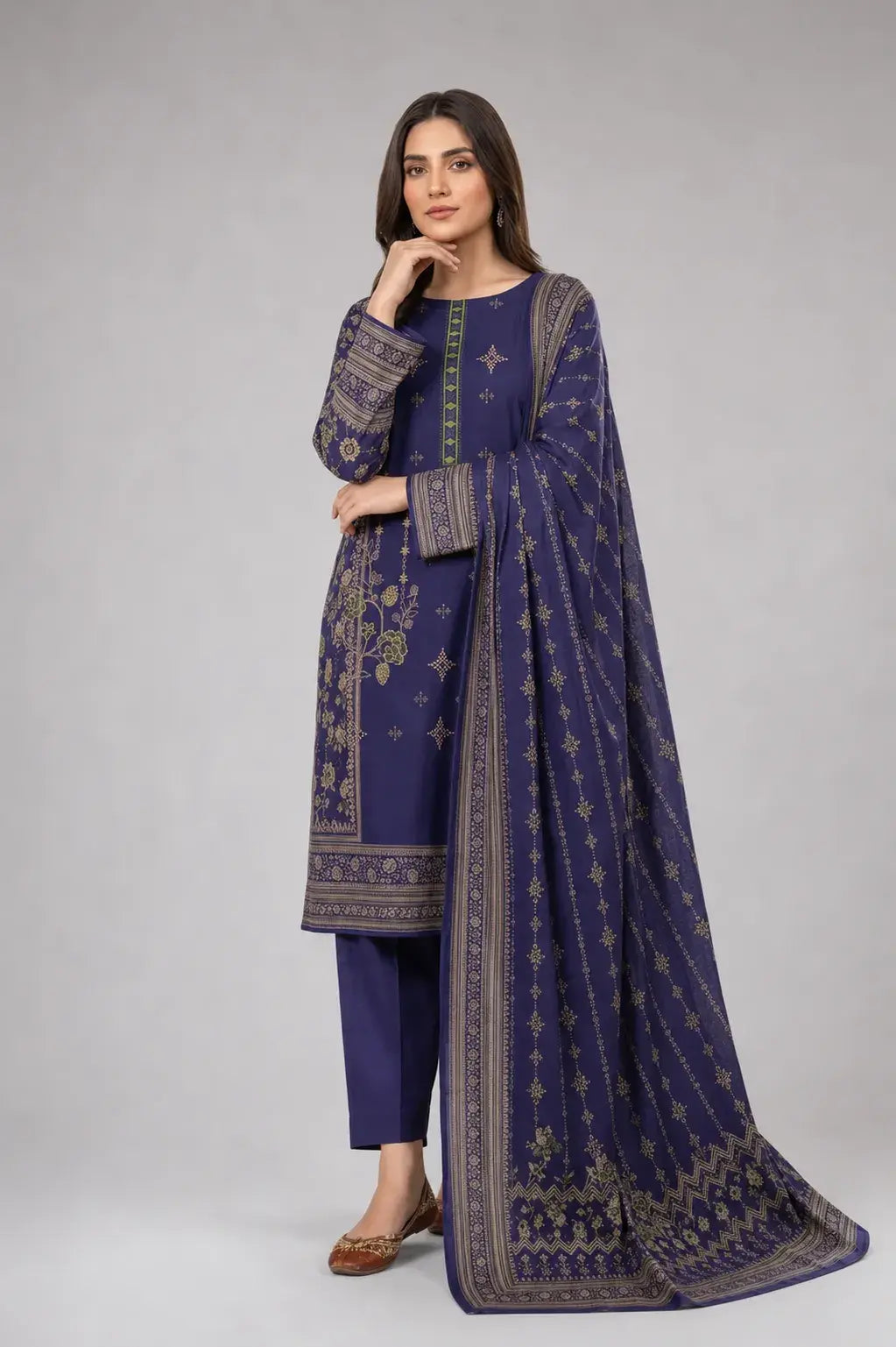 Woman wearing a luxury lawn digital print dress in blue color with intricate patterns on a gray background